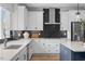 Kitchen showcases white cabinets, quartz counters, stainless appliances, tile backsplash and undermount sink at 4504 Mint Leaf Ln, Raleigh, NC 27612
