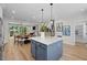 Kitchen island with sink is the center piece for a space adjacent to dining and living spaces at 4504 Mint Leaf Ln, Raleigh, NC 27612