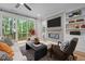 Inviting living room boasts modern fireplace, built-in shelves, and sliding doors to a deck at 4504 Mint Leaf Ln, Raleigh, NC 27612