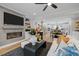Open concept living room features modern fireplace and flows into the kitchen and dining area at 4504 Mint Leaf Ln, Raleigh, NC 27612