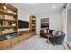 Comfortable living room featuring built-in shelving, a large TV, and a cozy sofa at 4504 Mint Leaf Ln, Raleigh, NC 27612