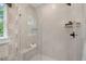 Beautifully tiled shower with a glass door, a built-in bench, and modern fixtures at 4504 Mint Leaf Ln, Raleigh, NC 27612