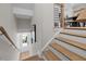 Elegant staircase with wood steps and metal railings leading to a bright foyer at 4504 Mint Leaf Ln, Raleigh, NC 27612