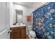 Bathroom featuring a wood vanity, framed mirror, floral curtain, and white ceramic toilet at 4524 Flat Bastion Drive Dr, Raleigh, NC 27610