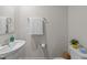 This half-bathroom has a white sink with an ornate faucet and a white towel hanging above the toilet at 4524 Flat Bastion Drive Dr, Raleigh, NC 27610