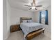 This bedroom features a wooden bed frame, ceiling fan, and a window with blue curtains at 4524 Flat Bastion Drive Dr, Raleigh, NC 27610