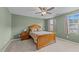 The Primary bedroom features a wooden bed frame with a ceiling fan and neutral color palette at 4524 Flat Bastion Drive Dr, Raleigh, NC 27610