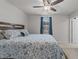A relaxing bedroom featuring a bed frame, a ceiling fan, and a window with blue curtains at 4524 Flat Bastion Drive Dr, Raleigh, NC 27610