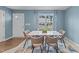 Bright dining area with a white marble table, stylish chairs, and views of the neighborhood at 4524 Flat Bastion Drive Dr, Raleigh, NC 27610