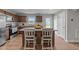 Modern kitchen with granite countertops, wooden cabinetry, stainless steel appliances, and island seating at 4524 Flat Bastion Drive Dr, Raleigh, NC 27610
