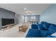 Spacious living room with comfortable seating, neutral carpet, and a view into the adjacent dining area at 4524 Flat Bastion Drive Dr, Raleigh, NC 27610