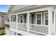 An elevated view of the spacious balcony showing the architectural details, including the white railing and gray exterior at 4803 Stony Falls Way, Knightdale, NC 27545