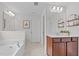 Bathroom featuring a glass-enclosed shower, a large soaking tub, and a vanity at 4803 Stony Falls Way, Knightdale, NC 27545