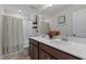 Bathroom featuring double sink vanity, large mirror, and shower with patterned curtain at 4803 Stony Falls Way, Knightdale, NC 27545