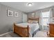 Cozy bedroom features a wooden bed frame and soft, neutral decor at 4803 Stony Falls Way, Knightdale, NC 27545