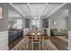 Elegant dining room showcasing an open-concept layout, seamlessly connecting to a cozy living space at 4803 Stony Falls Way, Knightdale, NC 27545