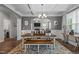 Elegant dining room with coffered ceilings, a wooden table and a view of the living area at 4803 Stony Falls Way, Knightdale, NC 27545