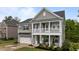 Charming two-story home with a welcoming front porch and a two-car garage, showcasing classic architectural details at 4803 Stony Falls Way, Knightdale, NC 27545