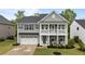 Charming two-story home with a welcoming front porch and a two-car garage, showcasing classic architectural details at 4803 Stony Falls Way, Knightdale, NC 27545