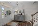 Inviting foyer with hardwood floors, a decorative mirror, and staircase, creating a warm welcome at 4803 Stony Falls Way, Knightdale, NC 27545