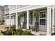 Inviting front porch featuring rocking chairs and greenery, creating a cozy and welcoming entrance at 4803 Stony Falls Way, Knightdale, NC 27545