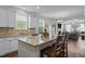 Open kitchen design with granite countertops, stainless appliances, and eat-in bar seating at 4803 Stony Falls Way, Knightdale, NC 27545