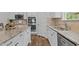 Updated kitchen featuring granite countertops, stainless steel appliances, and hardwood floors at 4803 Stony Falls Way, Knightdale, NC 27545