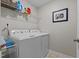 Bright laundry room with shelving, washer, and dryer perfect for easy chore management at 4803 Stony Falls Way, Knightdale, NC 27545