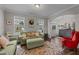 Cozy living room featuring comfortable seating, a decorative wreath, and natural light from multiple windows at 4803 Stony Falls Way, Knightdale, NC 27545
