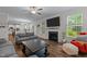 Open concept living room with fireplace, large TV, and view into the eat-in kitchen at 4803 Stony Falls Way, Knightdale, NC 27545