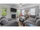 Inviting living room with a fireplace, large TV, and comfortable gray sectional sofa at 4803 Stony Falls Way, Knightdale, NC 27545