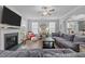 Bright living room with fireplace, TV, decorative wall art, and an open floor plan at 4803 Stony Falls Way, Knightdale, NC 27545