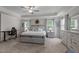 Bright main bedroom with lots of natural light, a desk, and modern furniture at 4803 Stony Falls Way, Knightdale, NC 27545