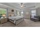Bright main bedroom with tray ceilings, lots of natural light, and modern furniture at 4803 Stony Falls Way, Knightdale, NC 27545
