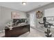 Home office space with a large desk, exercise bike and natural light from a window and door at 4803 Stony Falls Way, Knightdale, NC 27545