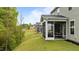 Backyard view with a screened porch providing an inviting outdoor living space and a grassy lawn at 4803 Stony Falls Way, Knightdale, NC 27545