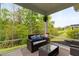 Comfortable screened porch with stylish wicker furniture, offering a relaxing space to enjoy views of the lush greenery at 4803 Stony Falls Way, Knightdale, NC 27545