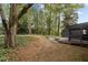 Lush backyard with mature trees, established landscaping, and an outdoor deck at 4812 Latimer Rd, Raleigh, NC 27609
