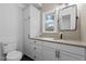 Bright bathroom features custom cabinets, neutral countertops and a window to the outside at 4812 Latimer Rd, Raleigh, NC 27609