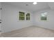 Bedroom with light wood floors and multiple windows at 4812 Latimer Rd, Raleigh, NC 27609