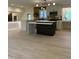Spacious kitchen with a large island, stainless appliances, and modern lighting fixtures at 4812 Latimer Rd, Raleigh, NC 27609