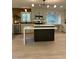 Bright kitchen features an island with white countertop, custom cabinets, and modern lighting at 4812 Latimer Rd, Raleigh, NC 27609