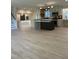 Open kitchen area with island, stainless steel appliances, and light wood floors at 4812 Latimer Rd, Raleigh, NC 27609