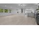 Open living space with light wood floors, large windows, and staircase at 4812 Latimer Rd, Raleigh, NC 27609