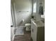 Bright bathroom featuring modern vanity, wood-look flooring, and neutral paint at 500 John St St, Clayton, NC 27520