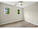Bright bedroom featuring neutral walls, wood-look flooring, and well-lit windows, creating a cozy space at 500 John St St, Clayton, NC 27520