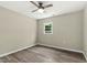 Bedroom featuring wood-look flooring, a ceiling fan, and a well-lit window, offering style at 500 John St St, Clayton, NC 27520