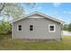 Gray home with white trim and three identical windows, renovated backyard at 500 John St St, Clayton, NC 27520