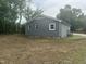 Gray sided renovated home with dark trim and a freshly seeded yard at 500 John St St, Clayton, NC 27520