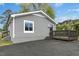 Charming single-story home with grey siding, a cozy porch, and landscaped surroundings, exuding curb appeal at 500 John St St, Clayton, NC 27520